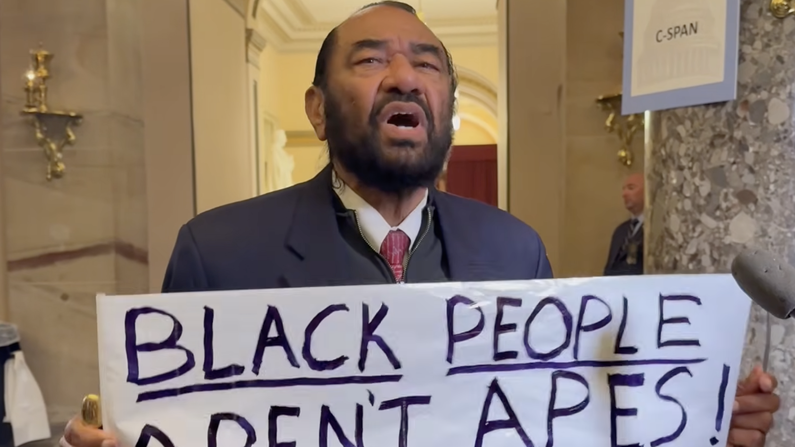 Rep. Al Green Escorted Out Of President Trump’s State Of The Union Address For Holding Up Sign Reading — “Black People Aren’t Apes”